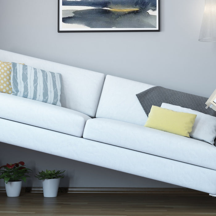 Large sofa crammed into a narrow room on an angle, "How to Make A Narrow Room Look Wider", from Estilo Living Blog