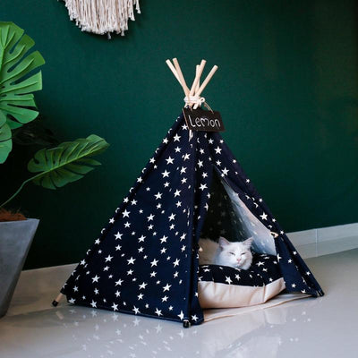 White cat sleeping in Navy Blue with White Stars Canvas Cotton Modern Boho Cat Teepee with Plush Cat Bed Cushion, from Pet Teepees and Pet Accessories Collection, at Estilo Living